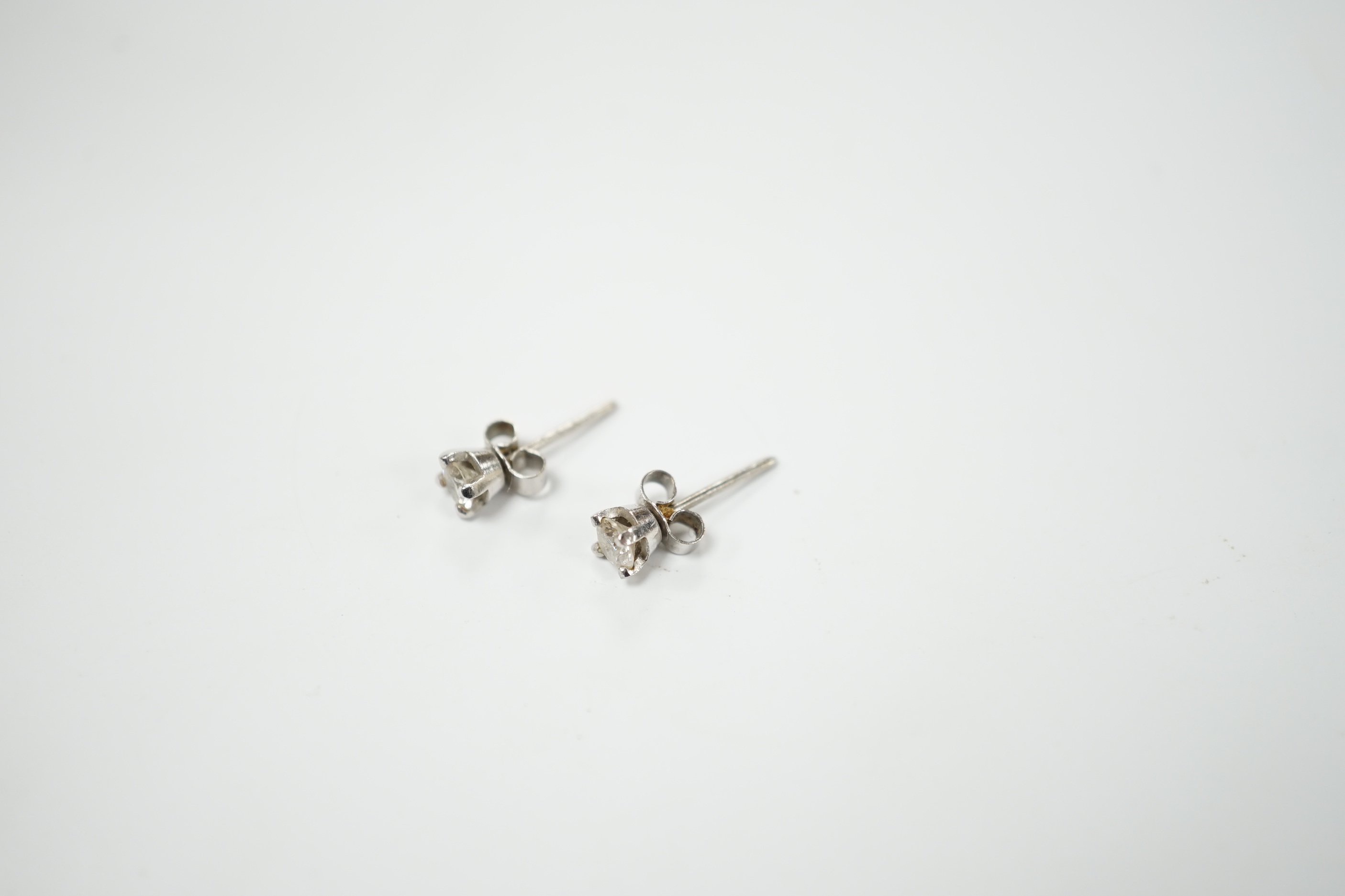 A pair of 9ct white gold solitaire diamond ear studs